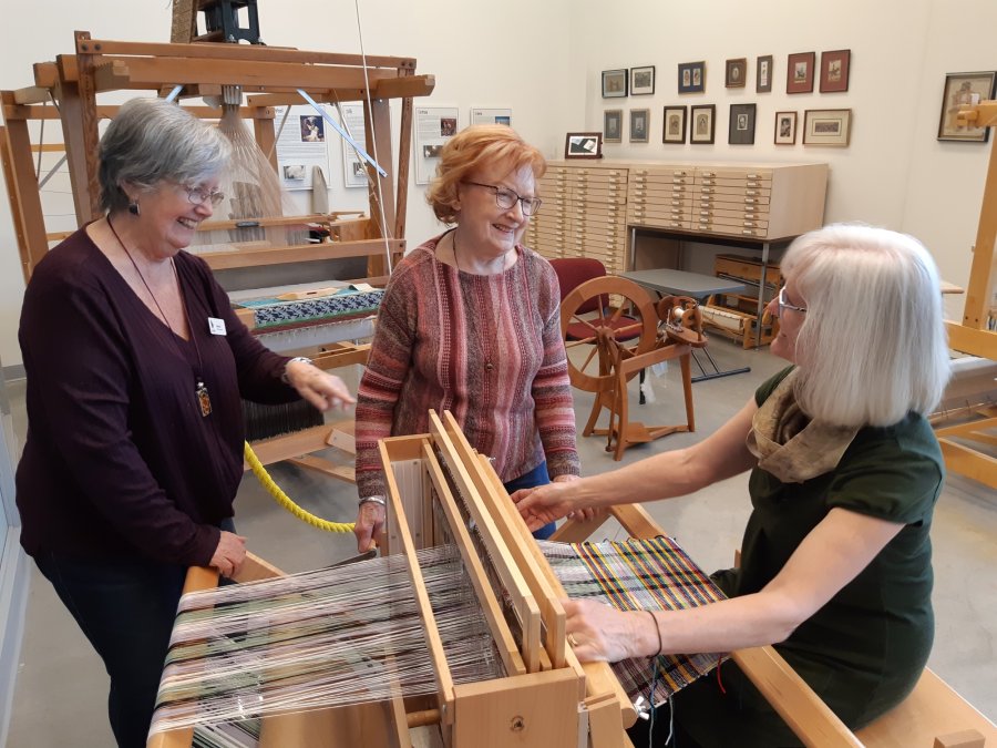 older adult volunteers at loom