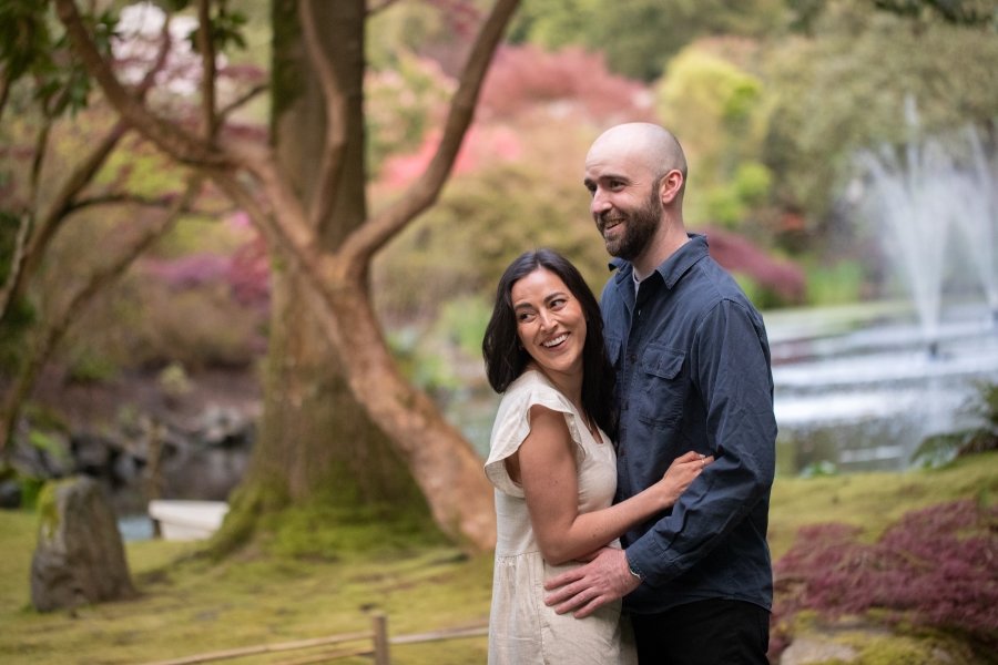 Couple standing in front of pond