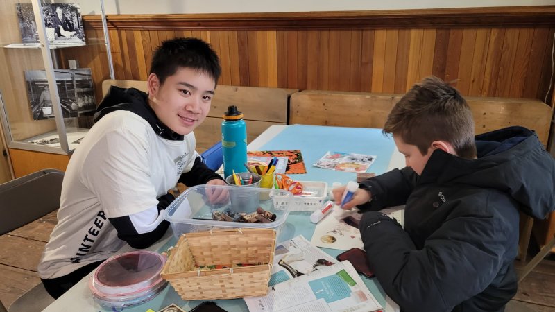 a volunteer leading a craft activity for children