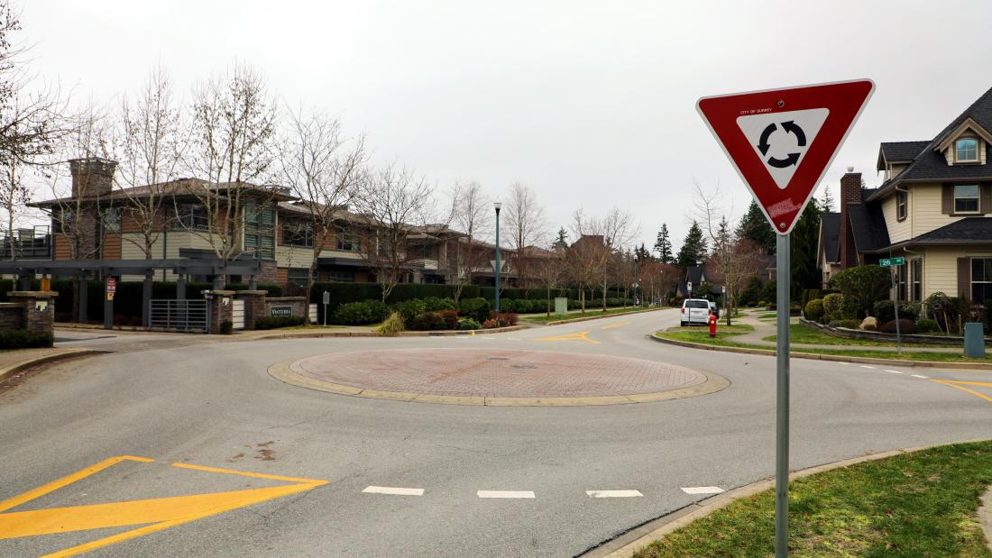 traffic circle with no vegetation with vehicles around it
