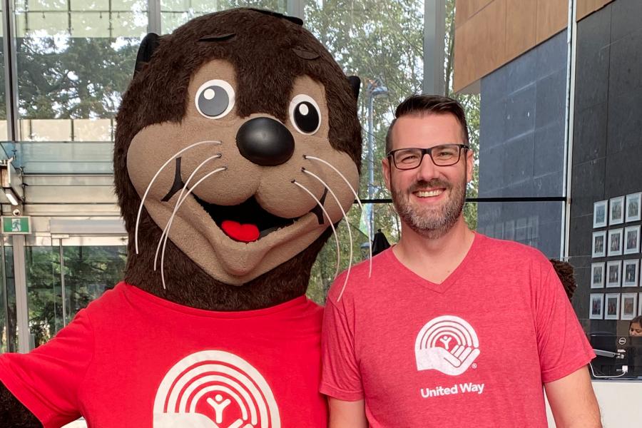 City of Surrey staff standing beside the United Way BC mascot