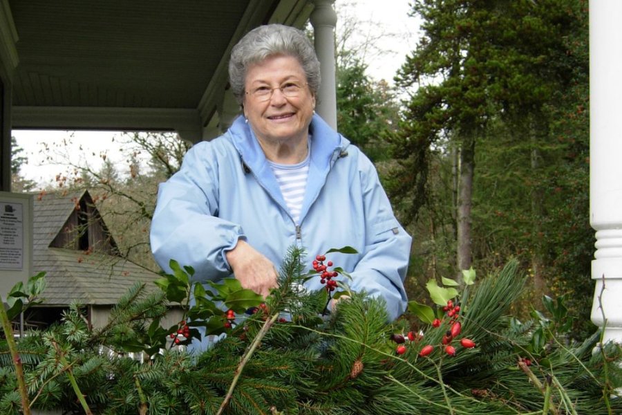 Volunteer Virginia Saunders on the verandah of the farmhouse