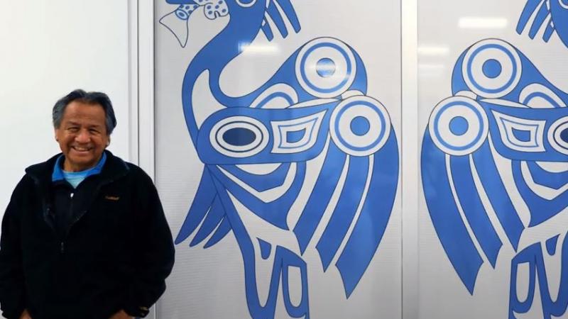 Artist Wes Antone Standing with Artwork