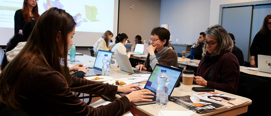 Participants at a Wikipedia edit-a-thon working on laptops in a collaborative setting.