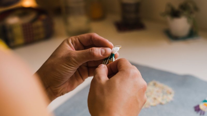 A woman beading