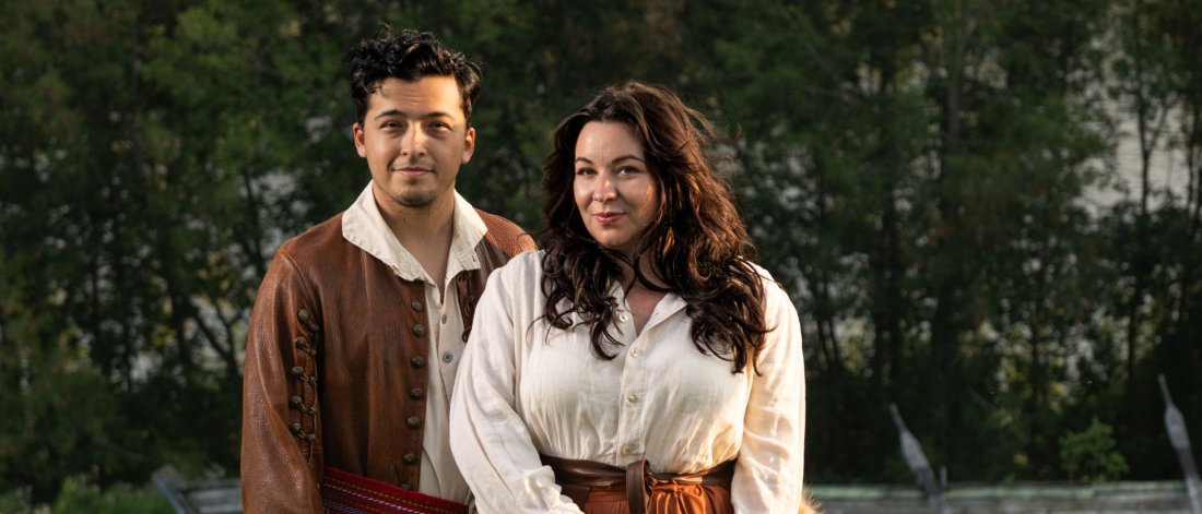 Image of show actors standing in a field