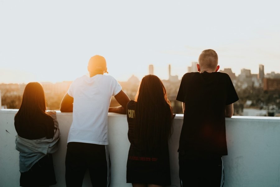 youth looking over a ledge at a cityscape