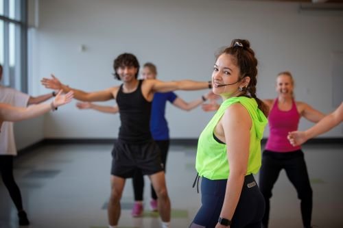 A fitness instructor in a neon green shirt.