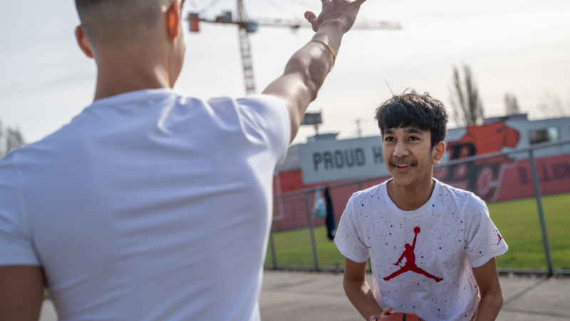 two youth playing basketball