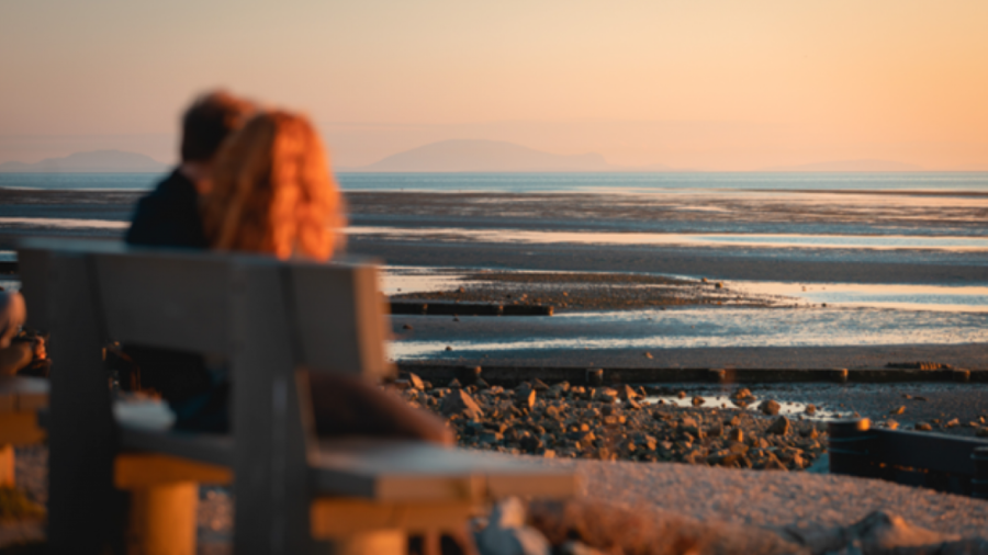 couple resting by the water