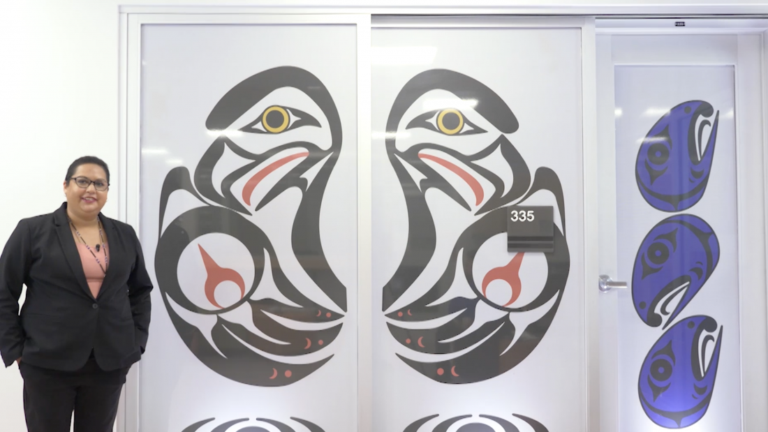Dianna Point with her artwork of black and red eagles