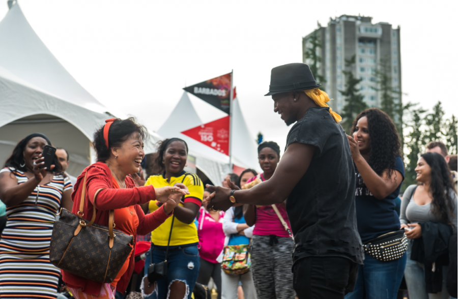 a performer charms the audience outdoors
