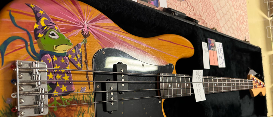 A bass guitar featuring art on the body