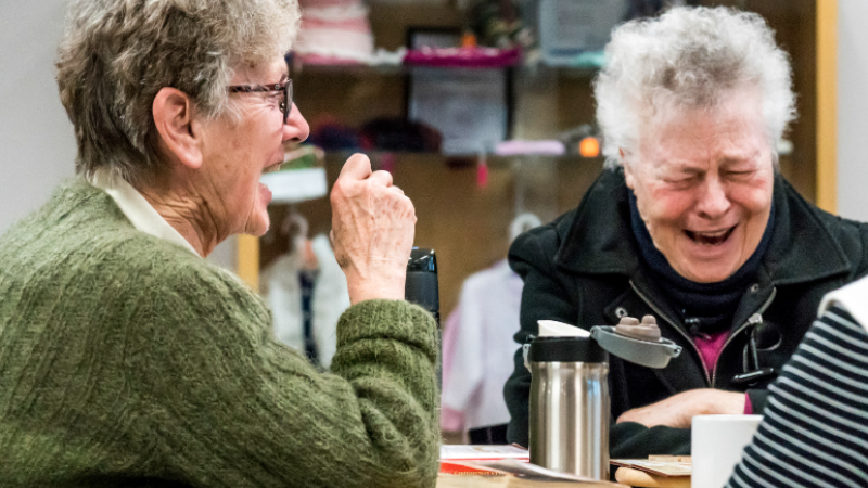 Two seniors laughing.