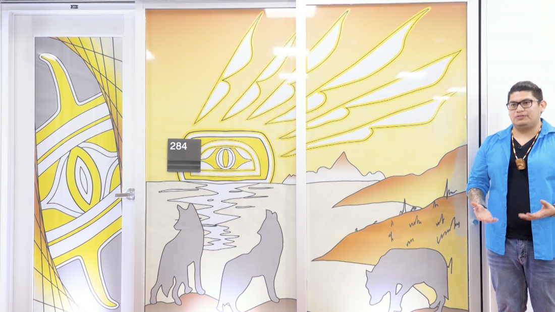 Rain Pierre with his artwork of grey wolves howling at sunset
